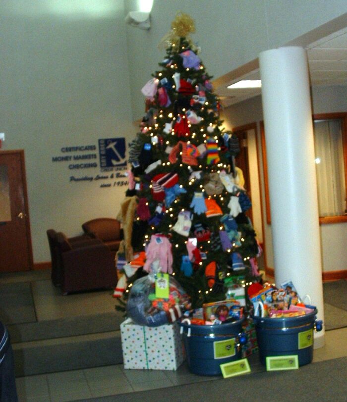 Lobby Christmas tree with a pile of gifts