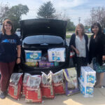 Volunteers showcasing the donation haul of kitty litter, cat food, paper towels and more supplies for Humane Ohio