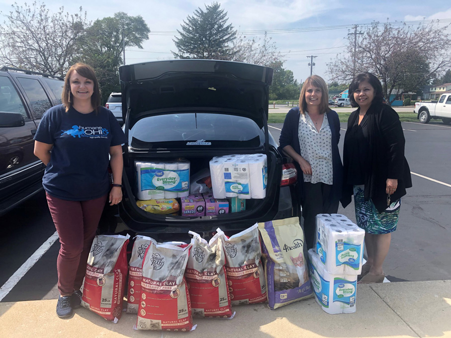 Volunteers showcasing the donation haul of kitty litter, cat food, paper towels and more supplies for Humane Ohio