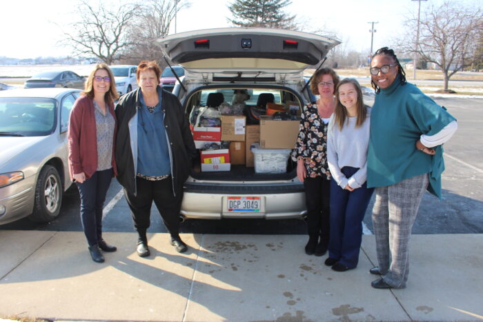 Posing with a van full of supplies