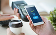 Man Using a Smartphone to Pay for Coffee