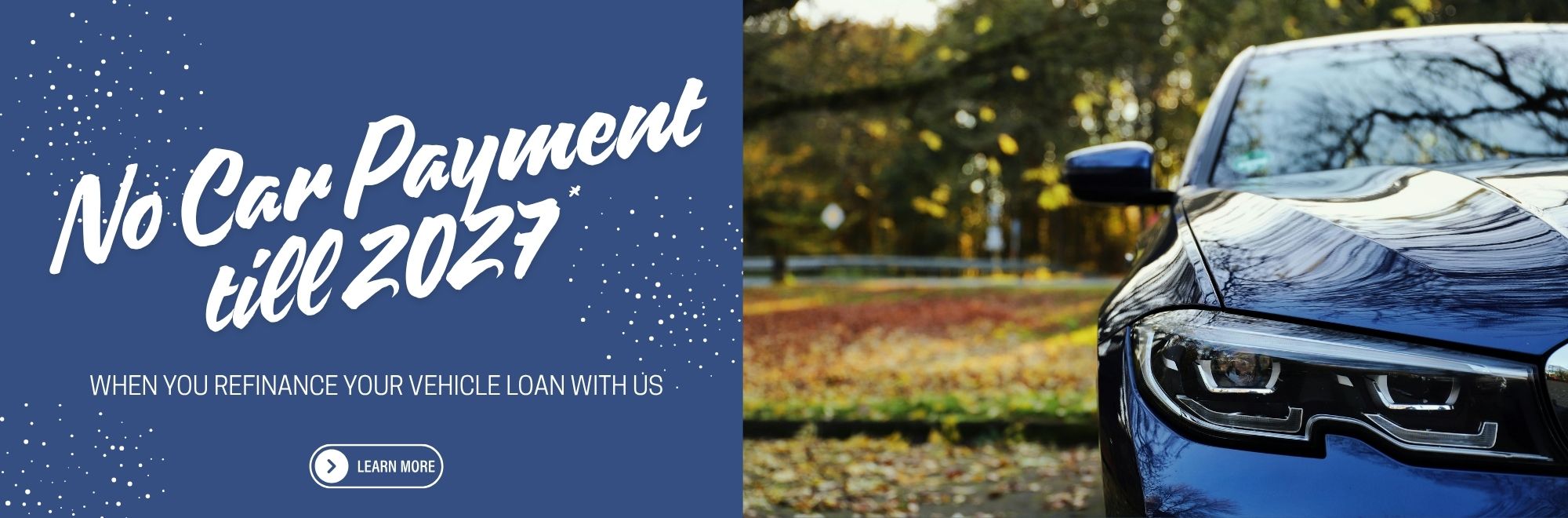Promotional website banner featuring a blue car parked against a scenic fall backdrop with colorful autumn leaves. Banner text reads, “No Car Payment Till 2027” and “When You Refinance Your Vehicle Loan With Us.” The image conveys seasonal savings and vehicle refinancing opportunities.