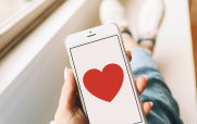 Man Holding Smartphone Displaying a Heart