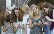 Group of Young Women Using Smartphones and Talking