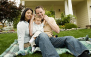 Young Couple with a Baby on the Lawn
