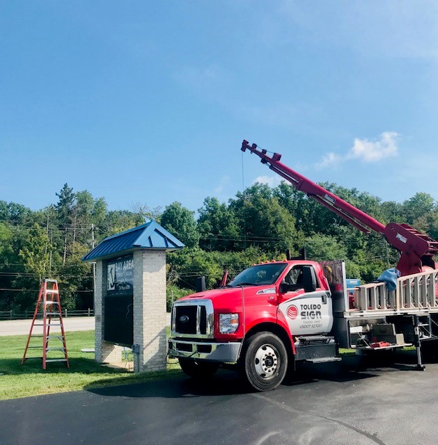 Crane hoisting our Toledo sign into place