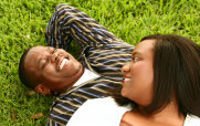 Man and Woman Laying in the Grass Laughing