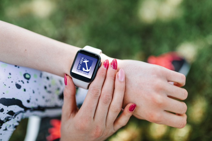 Woman's right hand checking the smartwatch notifications on her left wrist.