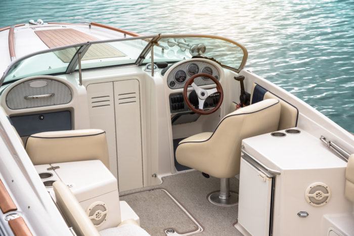 The deck and driving area of a small motorboat.