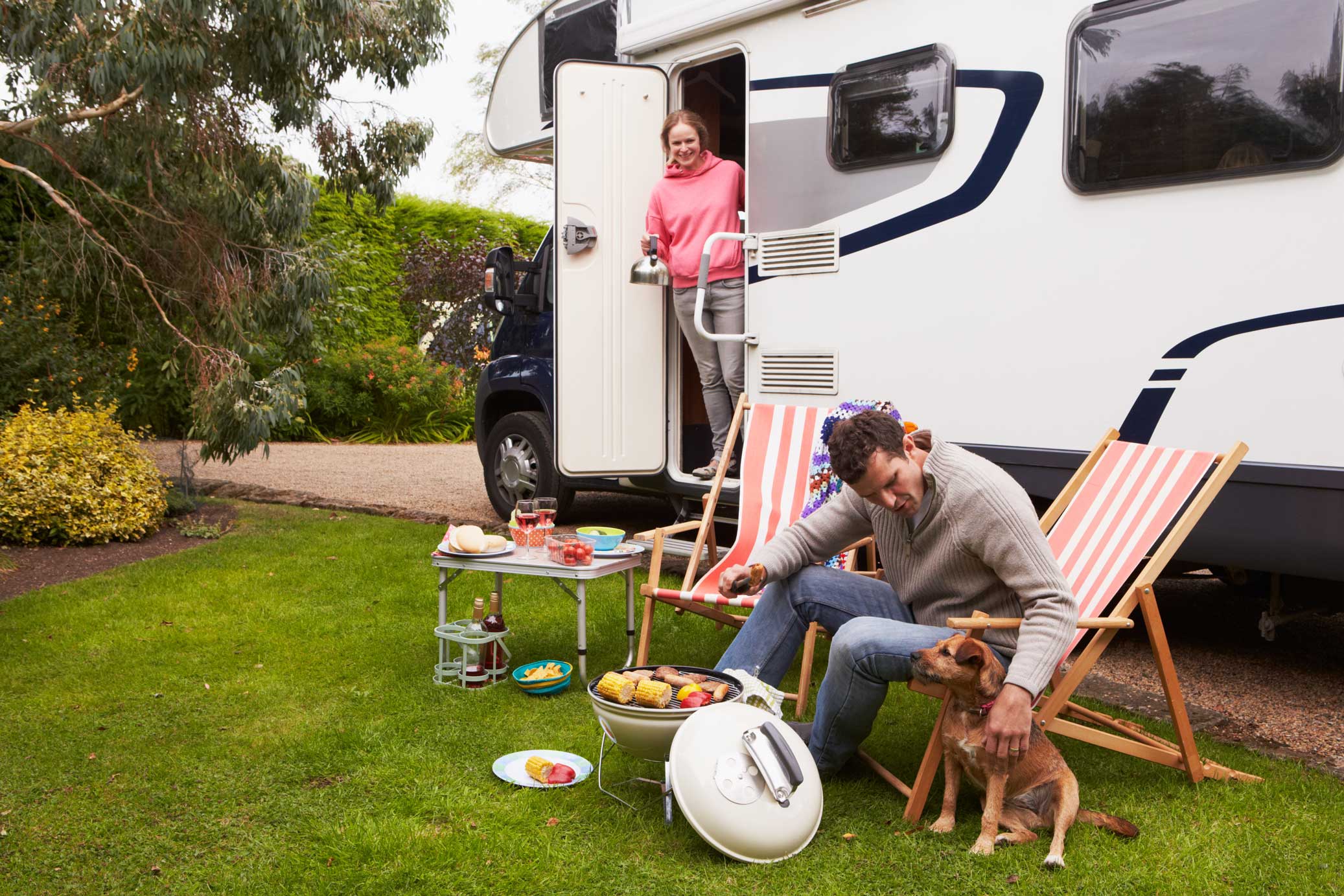 Couple enjoying grilling out in front of their RV