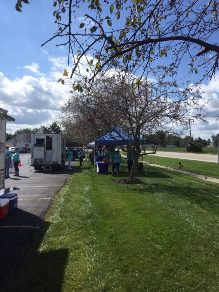 THX DAY event with members and community guests gathered outdoors, enjoying free food, conversation, and fellowship.